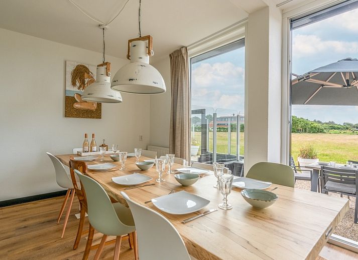Spacious terrace of Orchismient 17 vacation home in De Koog Texel, ideal for outdoor dining.