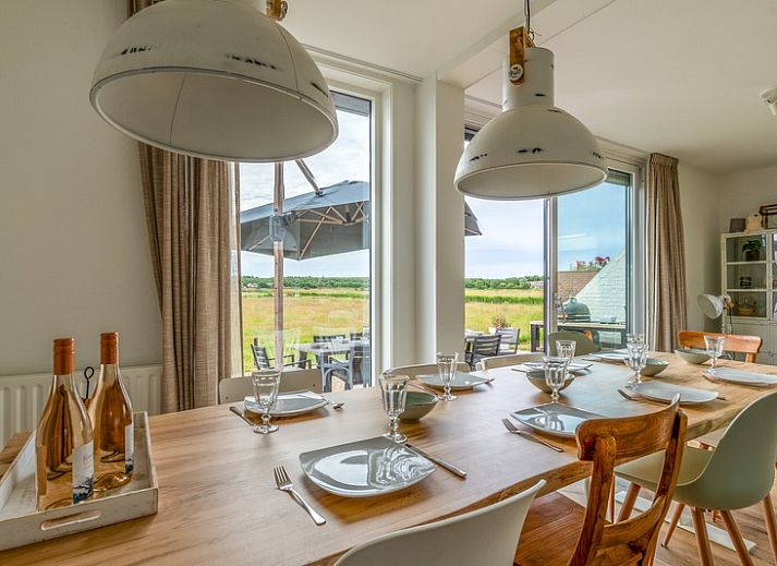 Spacious terrace of Orchismient 17 vacation home in De Koog Texel, ideal for outdoor dining.