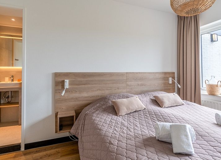 Spacious terrace of Orchismient 17 vacation home in De Koog Texel, ideal for outdoor dining.