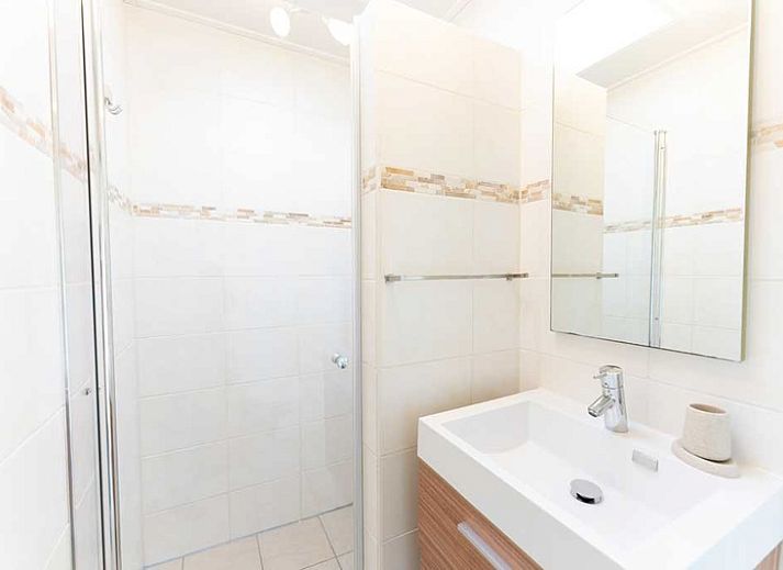 Cozy living room of De Koperwiek in De Koog Texel overlooking the garden.