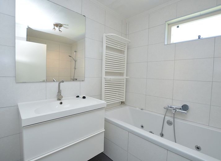 Spacious living room of Holiday home Stappeland 163, De Koog, Texel, with lots of natural light and comfortable furniture.