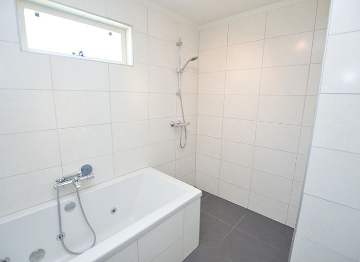 Spacious living room of Holiday home Stappeland 163, De Koog, Texel, with lots of natural light and comfortable furniture.