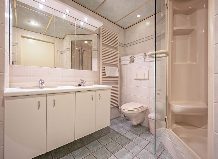 Cozy living room of Resort De Buteriggel - Apartment 9, De Koog, Texel with comfortable sofas and views of nature.