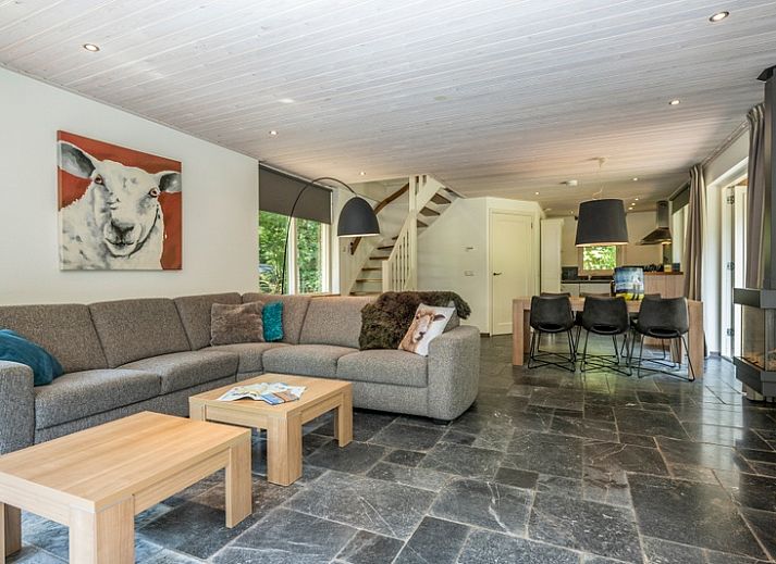 Vacation home Westenwind in De Koog, Texel with thatched roof and terrace among green trees.