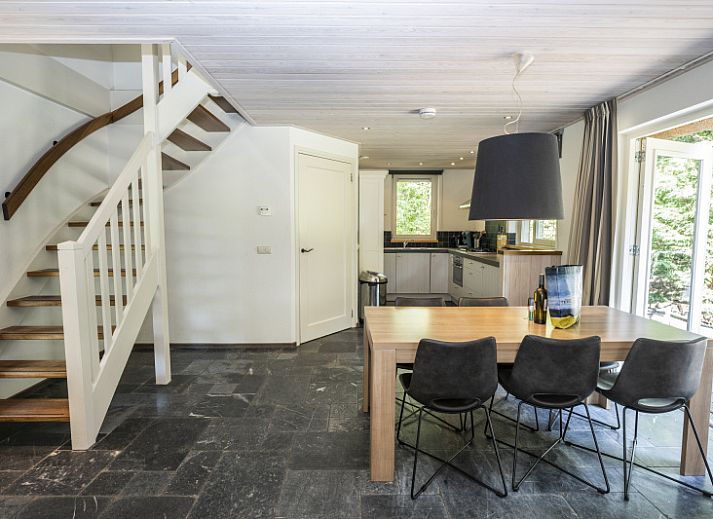 Cozy indoor area of Westenwind in De Koog, Texel with spacious sofa and access to the garden.