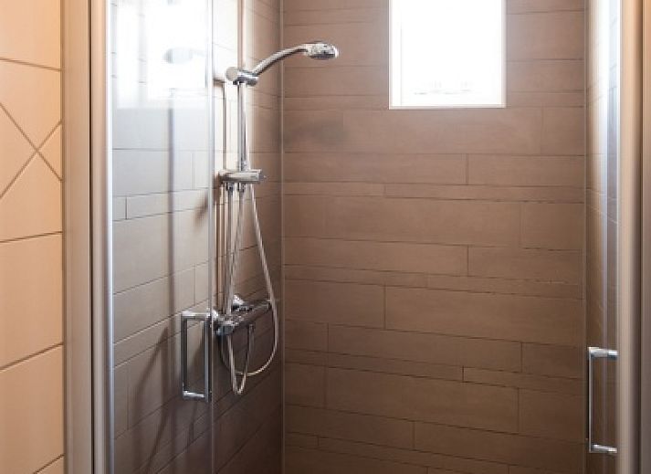 Villa 7 vacation home in De Koog Texel with spacious garden and terrace under a blue sky.