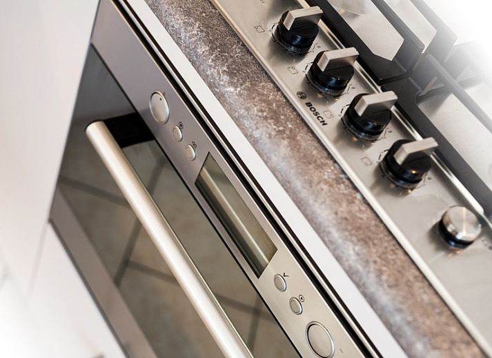 Child enjoys bath time in Villa 7 vacation home in De Koog Texel on the Wadden Islands.