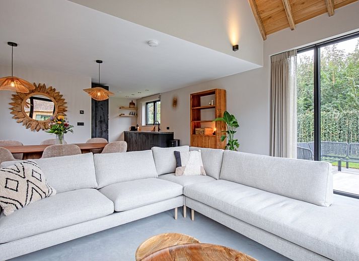 Veranda of Villa Jolie in De Koog, Texel, Wadden Islands, with comfortable seating and garden views.