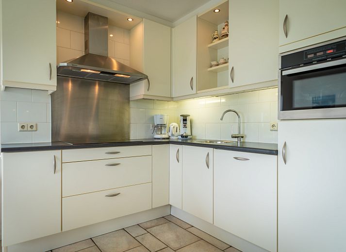 Enjoy the tranquility at Villa 6 persons in De Koog, Texel, a cozy vacation home with an inviting entrance and surrounded by nature.