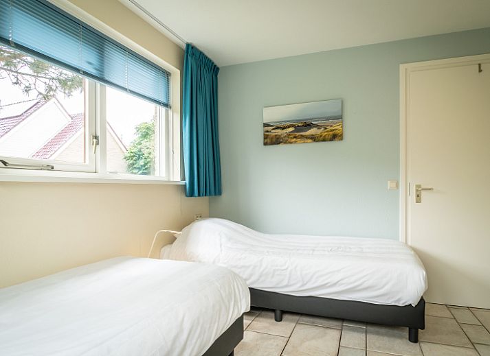 Enjoy the tranquility at Villa 6 persons in De Koog, Texel, a cozy vacation home with an inviting entrance and surrounded by nature.