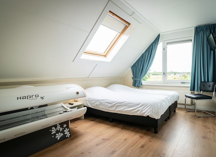 Enjoy the tranquility at Villa 6 persons in De Koog, Texel, a cozy vacation home with an inviting entrance and surrounded by nature.