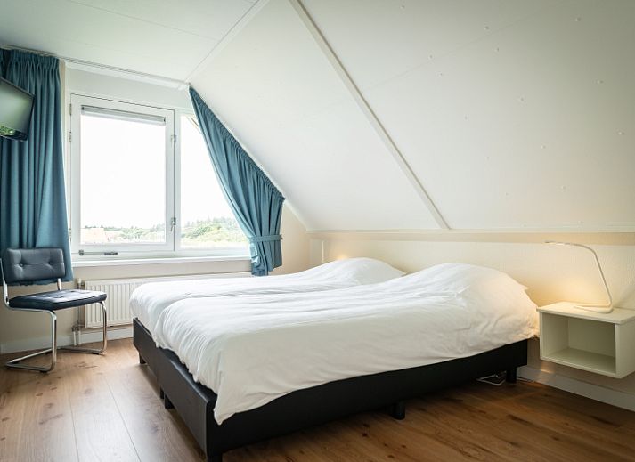 Enjoy the tranquility at Villa 6 persons in De Koog, Texel, a cozy vacation home with an inviting entrance and surrounded by nature.