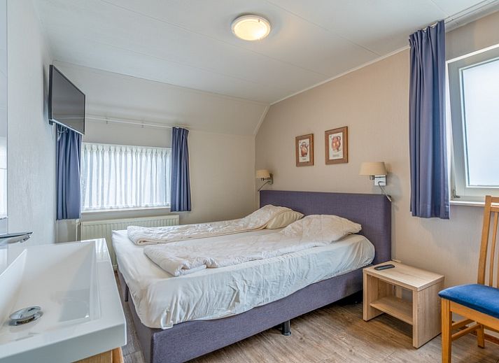 Cozy vacation home Honeysuckle 47 in De Koog, Texel with green surroundings and water feature.