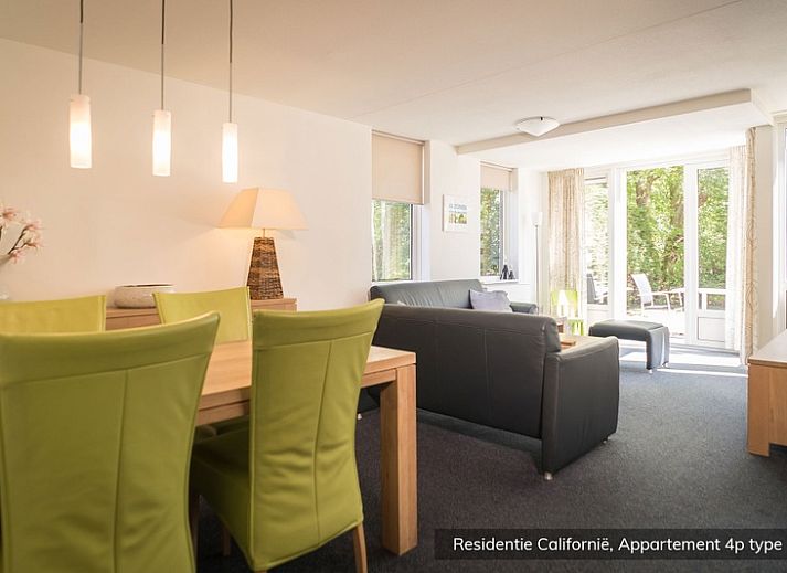 Spacious living room in Type 4 vacation home, De Koog, Texel. Comfortable sitting area with lots of natural light.