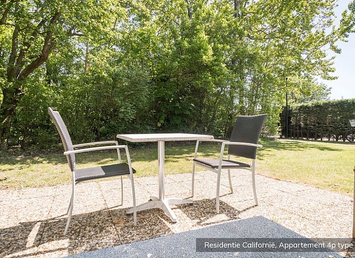 Spacious living room in Type 4 vacation home, De Koog, Texel. Comfortable sitting area with lots of natural light.