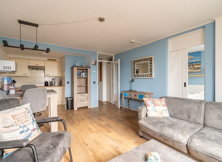 Gemuetliches Wohnzimmer des Appartements Juliana 076 Eilandzicht in De Koog, Texel mit Blick auf die Terrasse und viel Tageslicht.