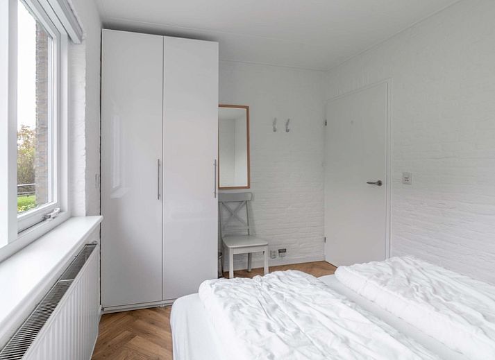 Cozy living room of Stappeland 197 in De Koog, Texel with modern furnishings and fireplace.