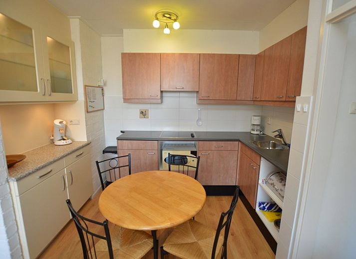 Bright living room of Apartment Kerckeland 50, De Koog, Texel with large windows and an inviting sofa.
