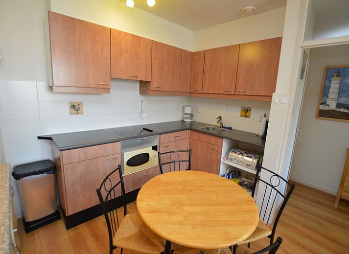 Bright living room of Apartment Kerckeland 50, De Koog, Texel with large windows and an inviting sofa.