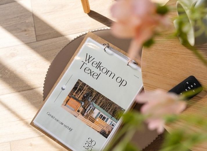 Bright living room in Chalet Bregkoog 24, De Koog, Texel, with comfortable chairs and large windows.