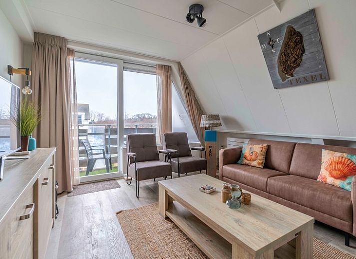 Gemuetliches Wohnzimmer von Apartment Anna 224 in De Koog, Texel mit Blick auf den Balkon.
