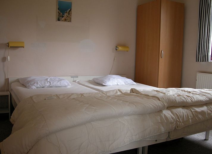 Bungalow Oud Vredelust 75 in De Koog, Texel, surrounded by green nature and flowers.