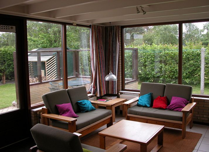 Bungalow Oud Vredelust 75 in De Koog, Texel, surrounded by green nature and flowers.