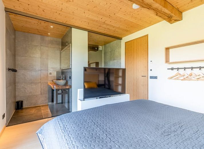 Cozy living room with fireplace in Holiday home in De Koog Texel, offers views of the nature of the Wadden Islands.