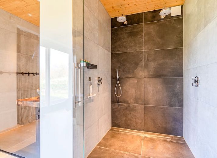 Modern living room with high ceilings in Holiday home in De Koog Texel, perfect for a luxurious stay on the Wadden Islands.