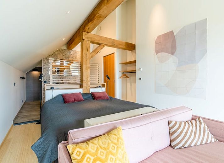 Comfortable sitting area with fireplace in Holiday home in De Koog Texel, overlooking the Wadden Islands garden.