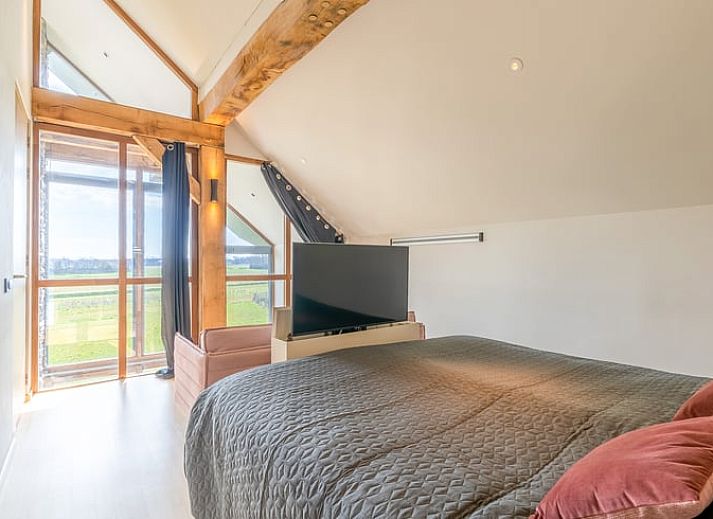 Comfortable sitting area with fireplace in Holiday home in De Koog Texel, overlooking the Wadden Islands garden.