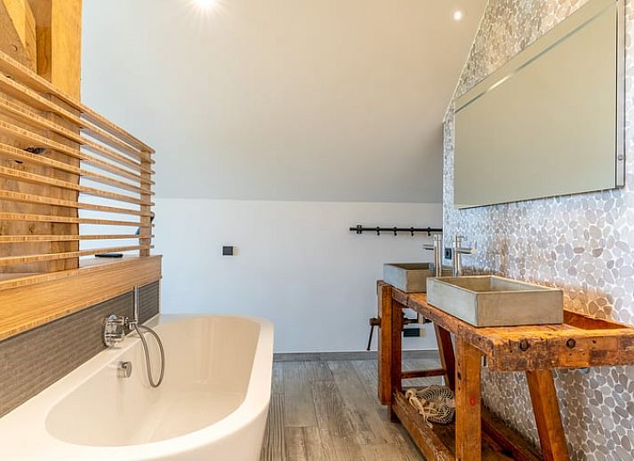 Comfortable sitting area with fireplace in Holiday home in De Koog Texel, overlooking the Wadden Islands garden.