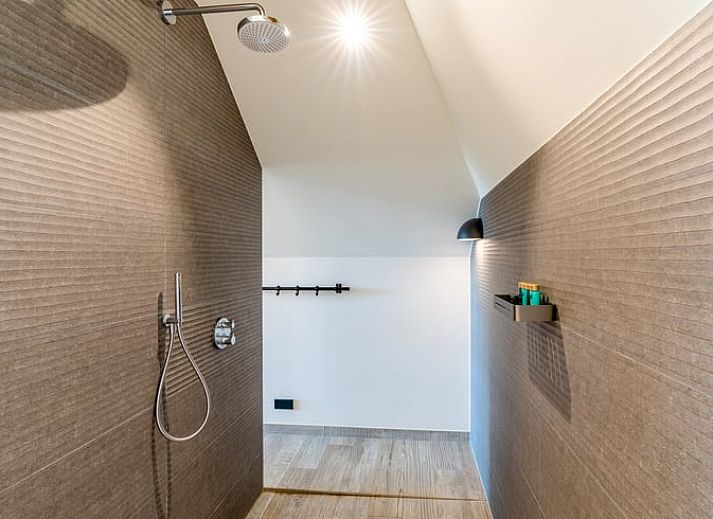 Comfortable sitting area with fireplace in Holiday home in De Koog Texel, overlooking the Wadden Islands garden.