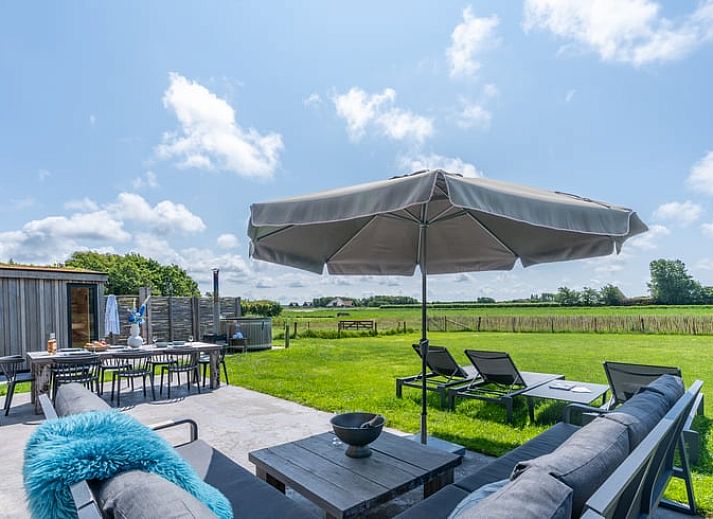 Stylish living room with open kitchen in Holiday home in De Koog Texel, ideal for a relaxing vacation on the Wadden Islands.
