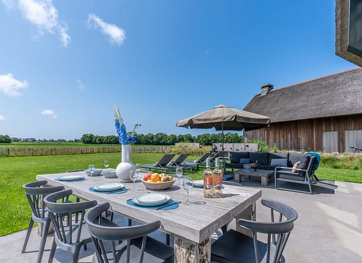 Stylish living room with open kitchen in Holiday home in De Koog Texel, ideal for a relaxing vacation on the Wadden Islands.