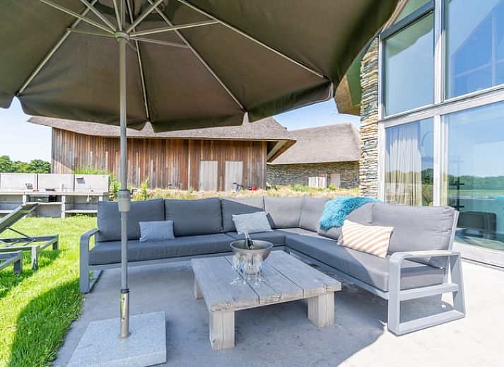 Stylish living room with open kitchen in Holiday home in De Koog Texel, ideal for a relaxing vacation on the Wadden Islands.