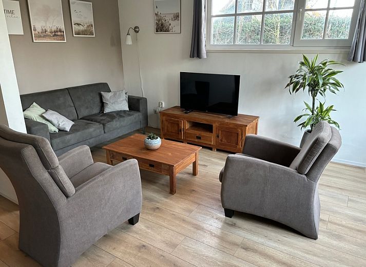 Spacious terrace at vacation home Stormvogel in De Koog, Texel with dining table and lounge sofa.