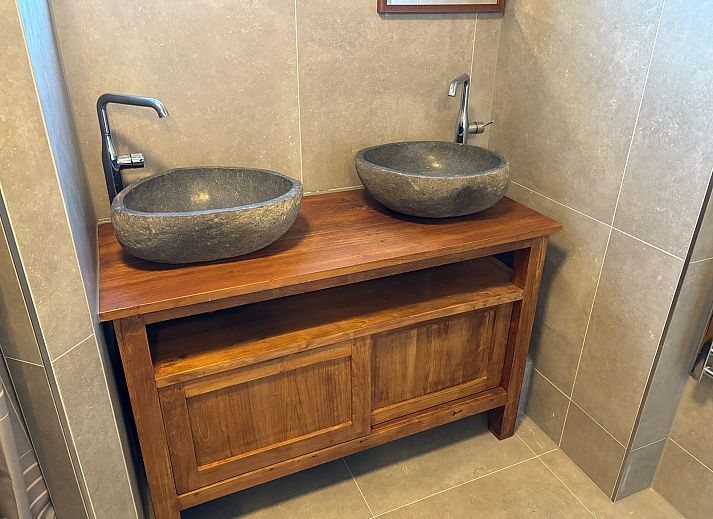 Cozy living room of Stormvogel, vacation home in De Koog, Texel with comfortable seating area.