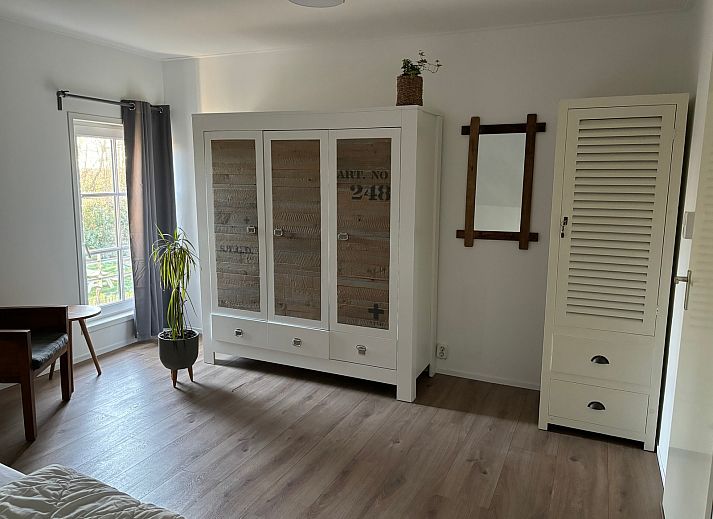 Cozy living room of Stormvogel, vacation home in De Koog, Texel with comfortable seating area.