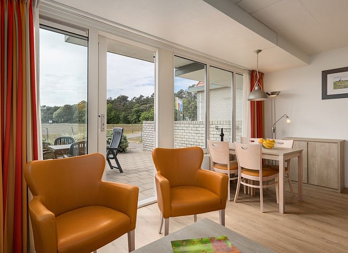 Cozy living room of B Apartment Comfort 4 in De Koog, Texel, with views of nature and an inviting terrace.