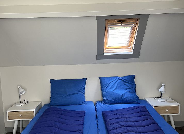 Gezellige woonkamer in 't Stulpje vakantiehuis De Koog Texel met eetruimte.