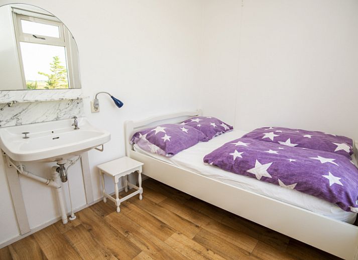 Sheep graze around Huisje Schiller - 4883, an idyllic vacation home in De Waal, Texel.