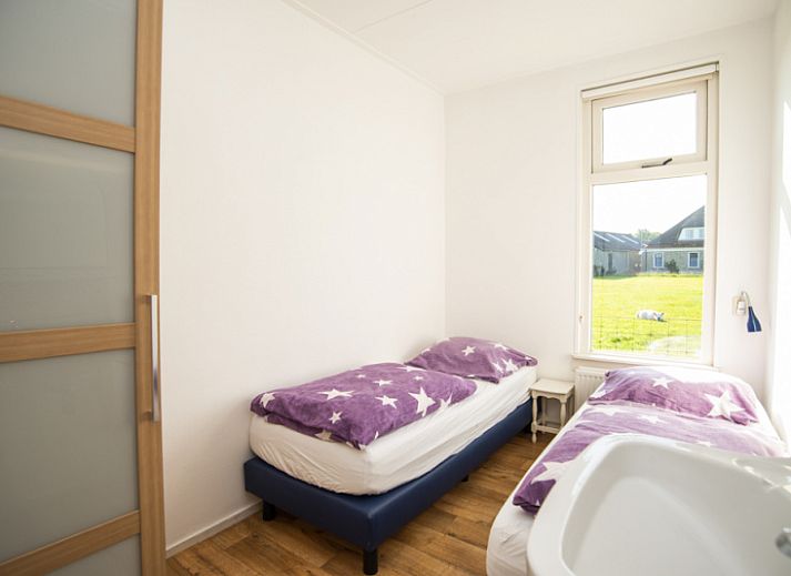 Sheep graze around Huisje Schiller - 4883, an idyllic vacation home in De Waal, Texel.