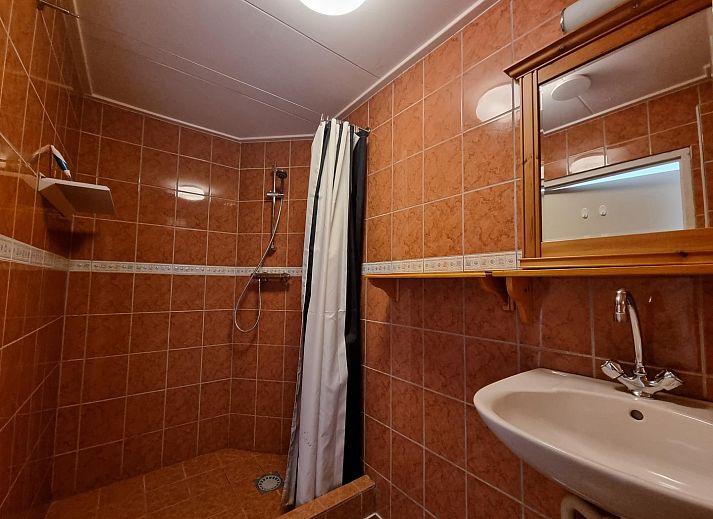 Essecke im Ferienhaus Weidezicht, Den Burg, Texel mit Holztisch und heller Kueche auf den Watteninseln.