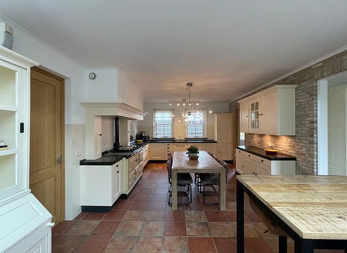 Cozy living room of Cottage in Den Burg, Texel with comfortable seating area and large windows.