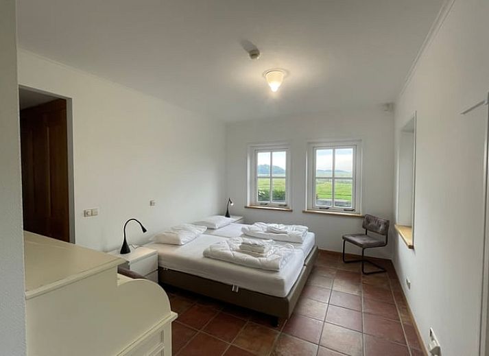 Cozy living room of Cottage in Den Burg, Texel with comfortable seating area and large windows.