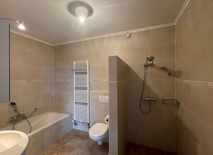 Cozy living room of Cottage in Den Burg, Texel with comfortable seating area and large windows.