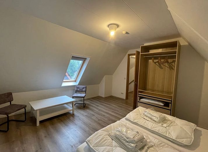 Cozy living room of Cottage in Den Burg, Texel with comfortable seating area and large windows.