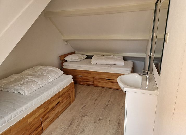 Gemuetliches Wohnzimmer im Ferienhaus Kogerstraat, Den Burg, Texel. Gemuetliche Sitzecke und Essbereich fuer einen entspannten Aufenthalt.