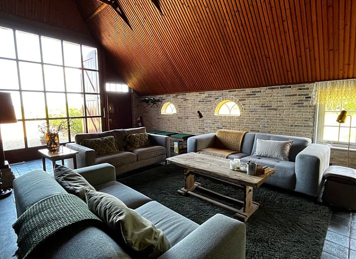 Rustikale Umgebung des Ferienhauses in Den Burg, Texel, mit einer authentischen Scheune und grossen Rasenflaechen.